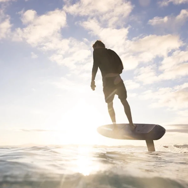 Fliteboard Ultra L3 - Lifestyle Image 5 Rider on a Fliteboard Ultra L3 eFoil gliding above the ocean during a golden sunset.